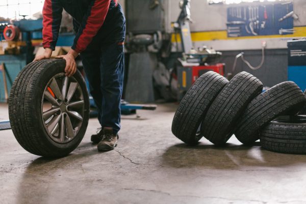 man moving a tire